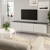 Modern living room with BESTÅ tv bench, flat-screen tv, coffee table, and cream sofa. Ample storage.
