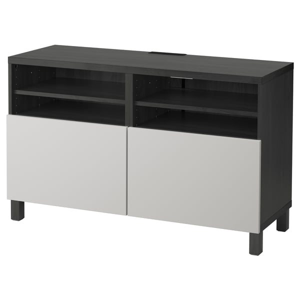 A black and white BESTÅ tv bench with cable management and adjustable hinges.