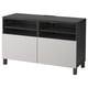 A black and white BESTÅ tv bench with cable management and adjustable hinges.