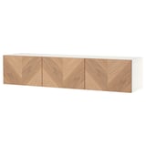 White BESTÅ tv bench with three wooden doors, herringbone pattern.
