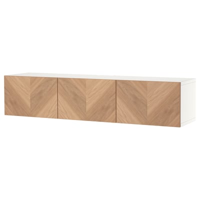 White BESTÅ tv bench with three wooden doors, herringbone pattern.