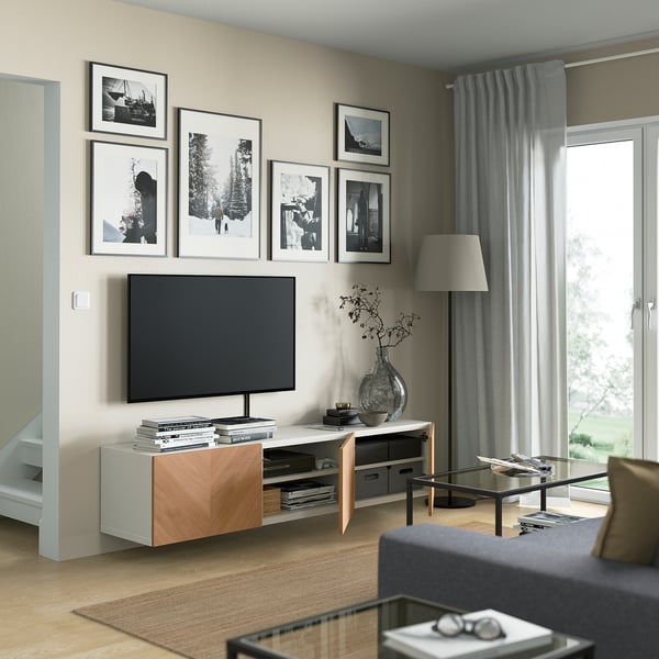 Modern living room with BESTÅ tv bench featuring adjustable shelves and cable management, showcasing contemporary design and practical storage.