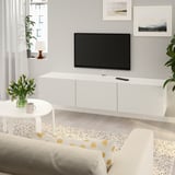 Modern living room with BESTÅ tv bench, flat screen tv, narrow coffee table, rug, and gray couch near large window.
