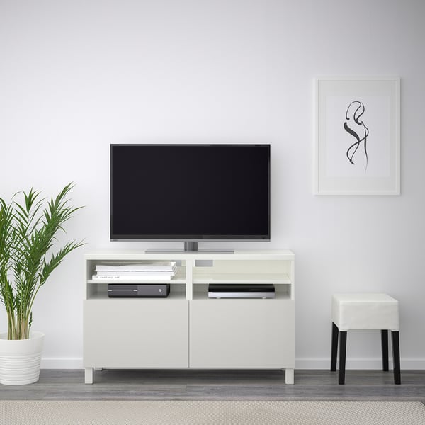 Modern living room with BESTÅ tv bench, flat screen, electronics, minimalist decor, black frame.
