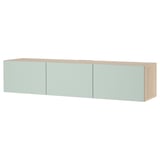 Modern wall-mounted tv unit: light wood, light green doors, rectangular shape, sleek design.