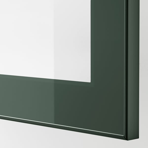 Close-up of green BESTÅ cabinet edge, showing sleek design and smooth finish.