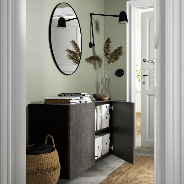 Modern wall-mounted cabinet with open doors, displaying organized storage solutions and a mirror above.