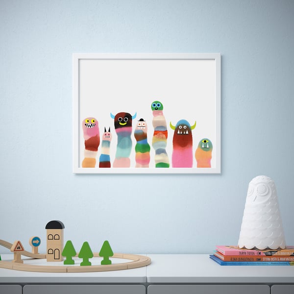 Colorful monster artwork and wooden toys on a shelf.