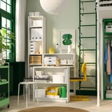 White BILLY bookcase with table, plants, and yellow chair.