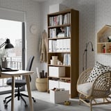 BILLY bookcase with adjustable shelves, natural wood finish in office setting.