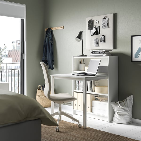 Home office: BILLY bookcase desk, chair, lamp, city view.