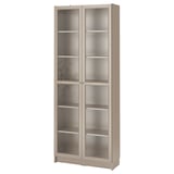 A BILLY bookcase, beige in color, with glass doors and adjustable shelves for storage.