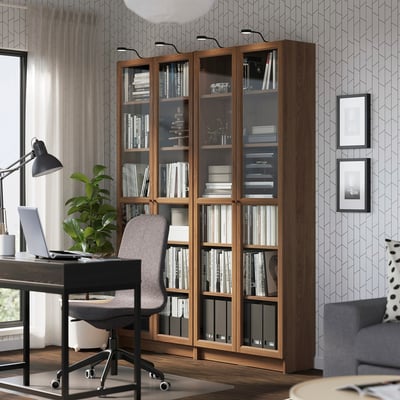 BILLY bookcase with glass doors in home office.