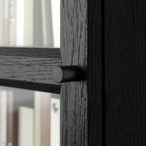 Close-up of BILLY bookcase hinge, showcasing its robust design and textured finish.