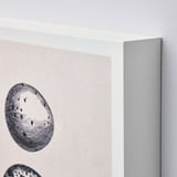 Black and white wall art close-up, showing intricate circular design and sleek frame edge.