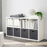 White BLÄDDRA storage box on shelf, fits kallax, made of recycled polyester, holds items neatly.