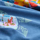 Blue towel with vibrant turtle print, soft and fluffy texture, ideal for comfort and absorption.