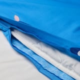 A blue duvet cover with a white zipper opening, showcasing its protective inner lining.