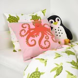 A colorful bedding set featuring an octopus pillow and turtle-patterned duvet cover, ideal for childrens comfort and easy care.