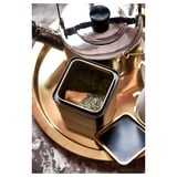 Metal tin with lid for storing tea, gold color, round shape, tinplated steel material.