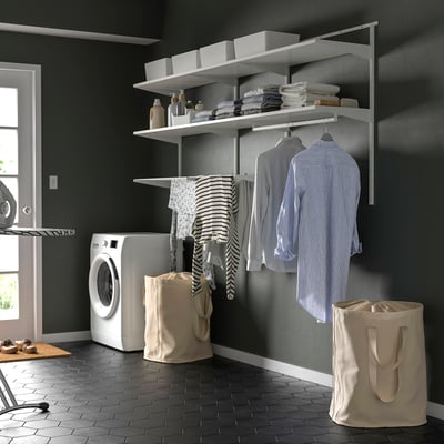 BOAXEL wall storage in laundry room with drying rack, clothes, and bags.