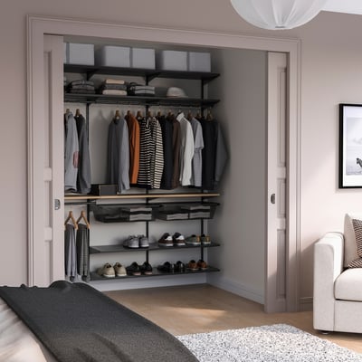 Modern closet with BOAXEL system, organized clothes, bed, couch. Or BOAXEL closet with dark clothes, light bedroom, bed, couch.