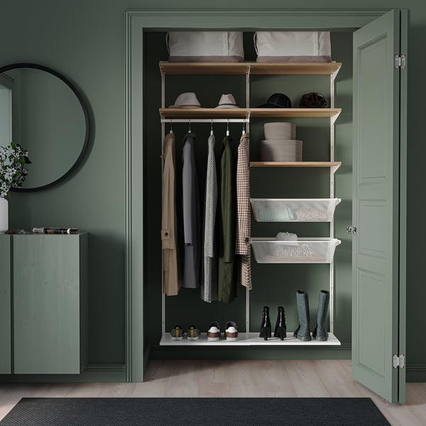 BOAXEL green wall storage with coats, accessories, hats, and mirror.