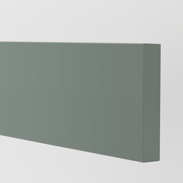 Close-up of smooth, matte green-gray cabinet door, showing modern finish.