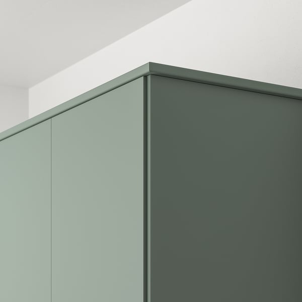 Close-up of modern grey-green kitchen cabinet edges, showcasing sleek design with smooth finishes.