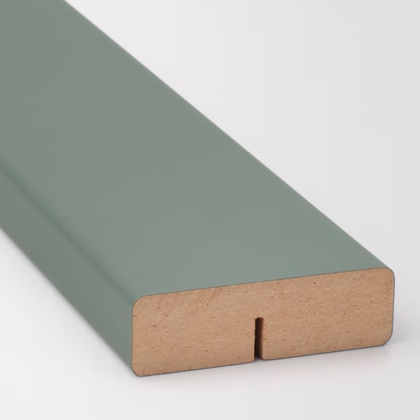 Close-up of sleek, modern teal kitchen cabinet front, showing smooth surface and sturdy edge in natural wood.