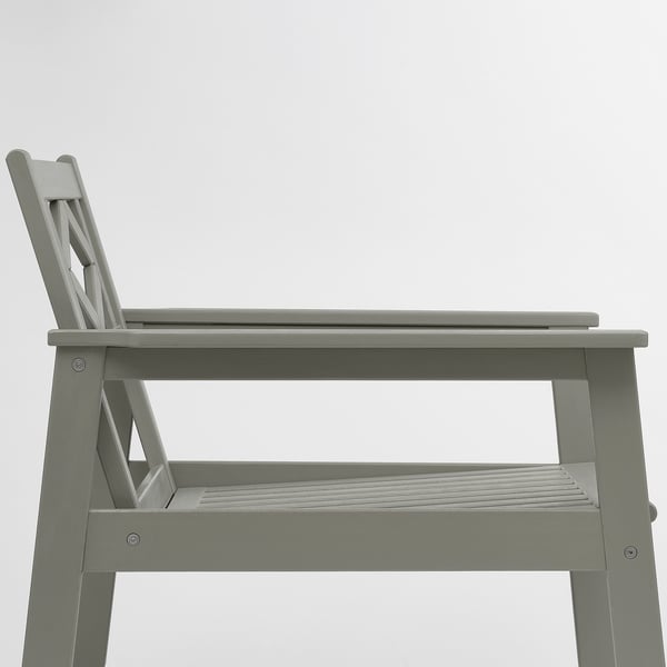 Gray outdoor wooden chair with metal legs and a slatted seat, shown from the side.