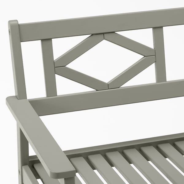 Durable outdoor bench with intricate back design and wide seat; made from eucalyptus wood.