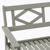 Durable outdoor bench with intricate back design and wide seat; made from eucalyptus wood.