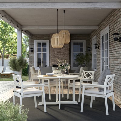 White acacia patio set with cushions, for covered porch dining.
