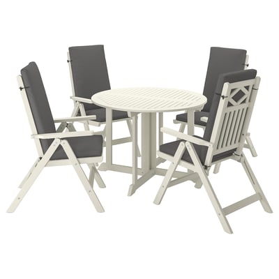 A BONDHOLMEN outdoor dining set with a white, round table and four matching reclining chairs with cushions. Elegant and functional for patio use.