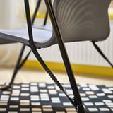 Close-up of BRÄNNBOLL chairs flexible cord and mesh, showing ergonomic back support.