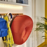 BRÄNNBOLL red inflatable chair on hooks, ready for quick seating.