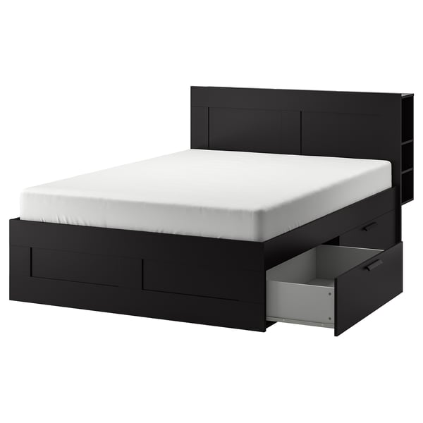 An ikea BRIMNES black bed with built-in storage drawers and a headboard.