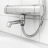 Image shows chrome shower mixer with attached hose. Safety stop at 38°c, cold touch for safety, and adjustable flow.