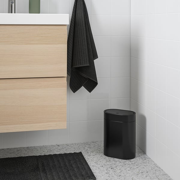 Black BROGRUND slim bin in bathroom, wall-mountable, complements modern decor.