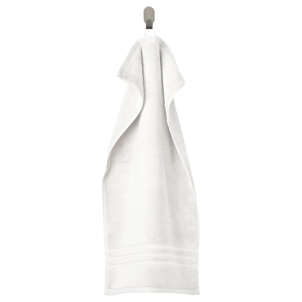 BROKGLIM towel: white, soft, organic cotton, rectangular, with elegant border, hanging.