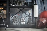 Black industrial shelf with metal gauges, levers, and red buoy.