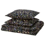 BRUDKRUSBÄR black floral duvet set made of 100% cotton with multicolored wildflowers, folded neatly.