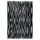 Black and white striped rectangular rug with a shaggy texture. Part of the nytillverkad collection, it a modern design with diagonal patterns.