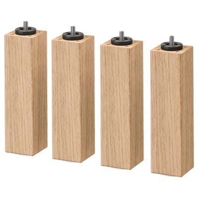 Four oak furniture legs with black metal fittings.