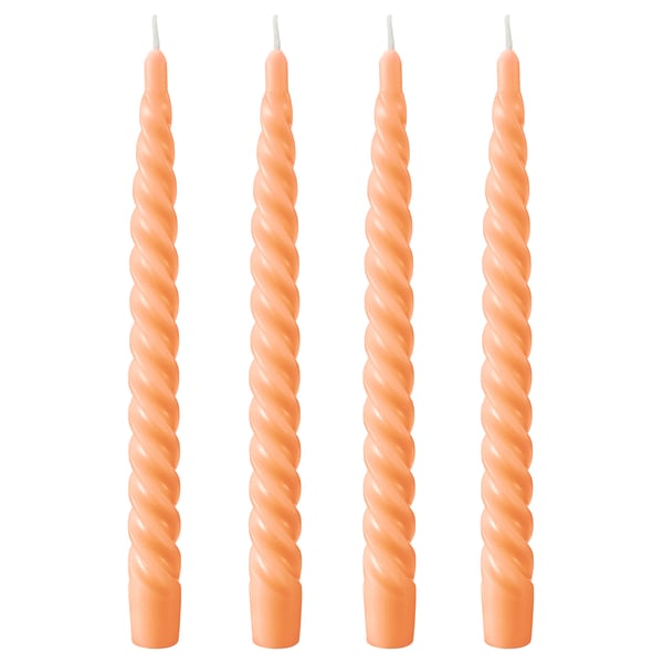 Four twisted orange candles side by side. Made of paraffin and plant-based wax, each with a cotton wick.