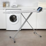 DÄNKA ironing board in laundry room, between washer & dryer, compact & sturdy.