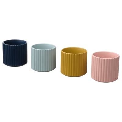 Four colorful cylindrical ceramic pots in navy, light blue, yellow, and pink with vertical groove designs, perfect for small plants or storage.