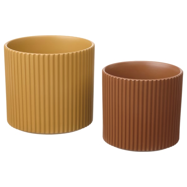 Two cylindrical plant pots, one mustard yellow, one terracotta, both with vertical grooves, made of earthenware.