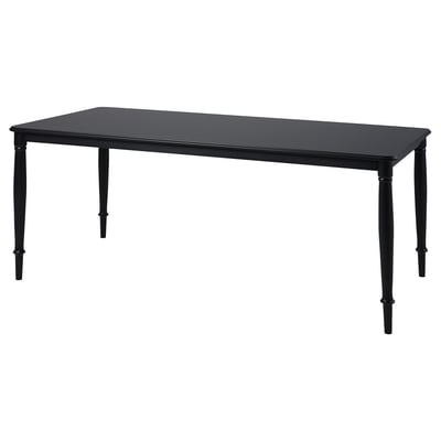 Black rectangular dining table with four tapered legs, made of steel and lacquered mdf.